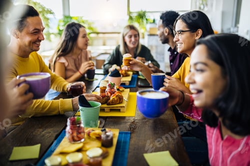 Preview: Happy group of multiracial friends having breakfast together