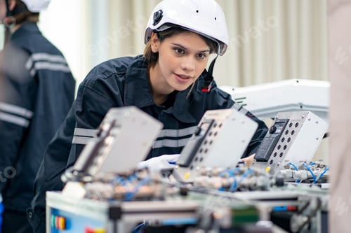 Preview: Female Engineer check and control automation robot arms machine in factory. robotics manufacturing.