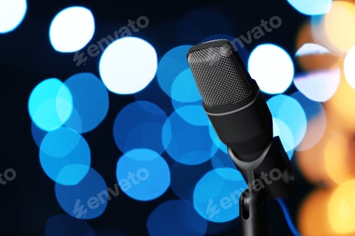 Preview: Microphone against festive lights, space for text. Musical equipment