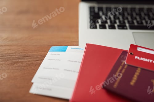Preview: Hard work deserves a vacation. Shot of travel documents and a laptop on a table.