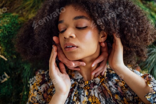 Preview: Female hands touch the neck of beautiful african american girl. Concept of femininity.