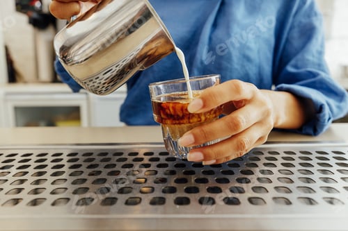Preview: Close up of female barista making a flat white coffee