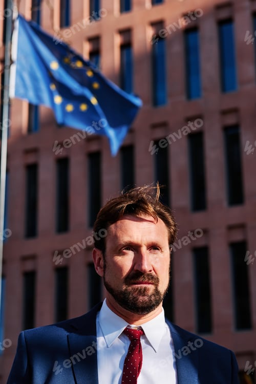Preview: Businessman in front of a building with the European flag
