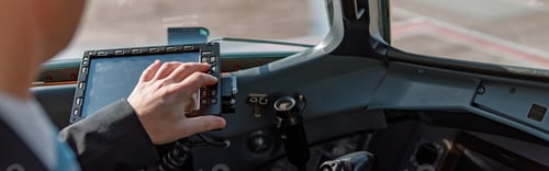 Preview: Aircraft pilot sitting in cockpit and using flight display