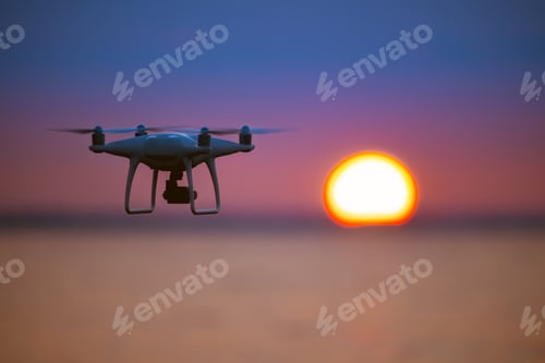 Preview: The copter flighting on the sunrise background