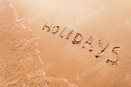 Preview: Holidays concept. Letters holidays on the beach. Eyer bird view. Yellow sand and draft holidays