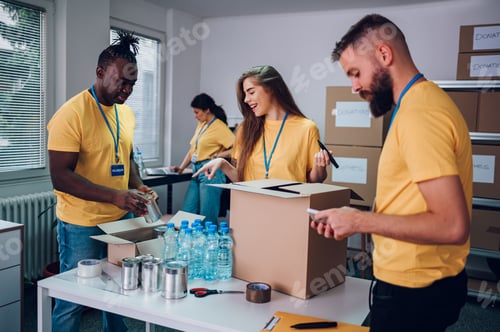 Preview: Group of multiracial volunteers working in community charity donation center