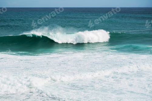 Preview: view from the beach to a tropical island and some granite rocks in the sea