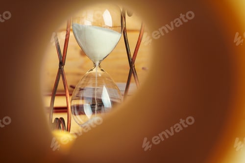 Preview: Close up of book page on a background of hourglass