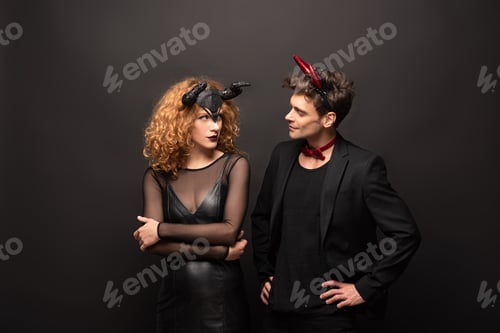 Preview: beautiful couple posing in halloween costumes on black