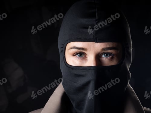 Preview: Portrait of a girl in a black balaclava and beige coat.