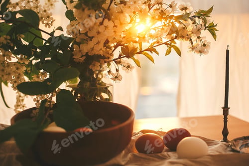 Preview: Natural Easter eggs and vintage candle in sunset warm light