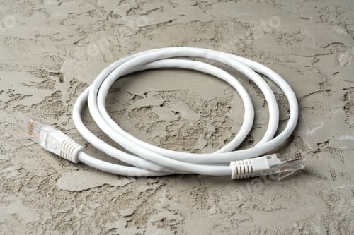 Preview: White network cable patch-cord on gray textured background