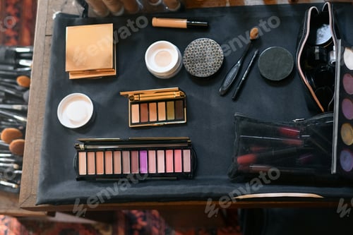 Preview: Cosmetics on the table lipstick foundation brush shadow