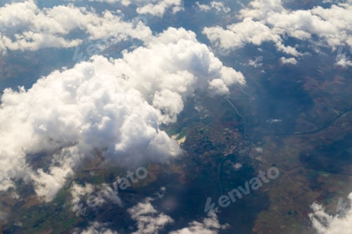 Preview: Aerial view of cloud and sky from airplane window looking down to land ,Nature background