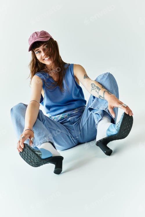 Preview: Stylish young woman showcasing fashionable attire and confidence in a playful pose