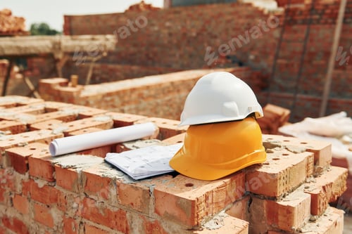 Preview: Close up view of protective hard hats that laying down on the bricks