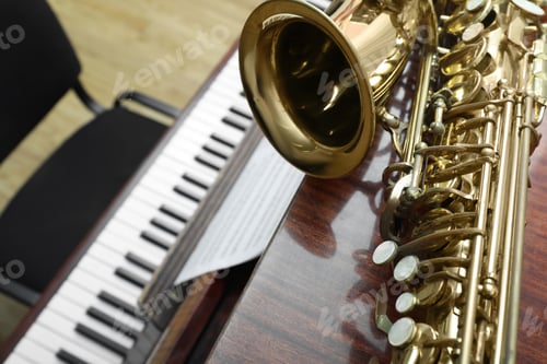 Preview: Beautiful saxophone on piano, closeup. Space for text