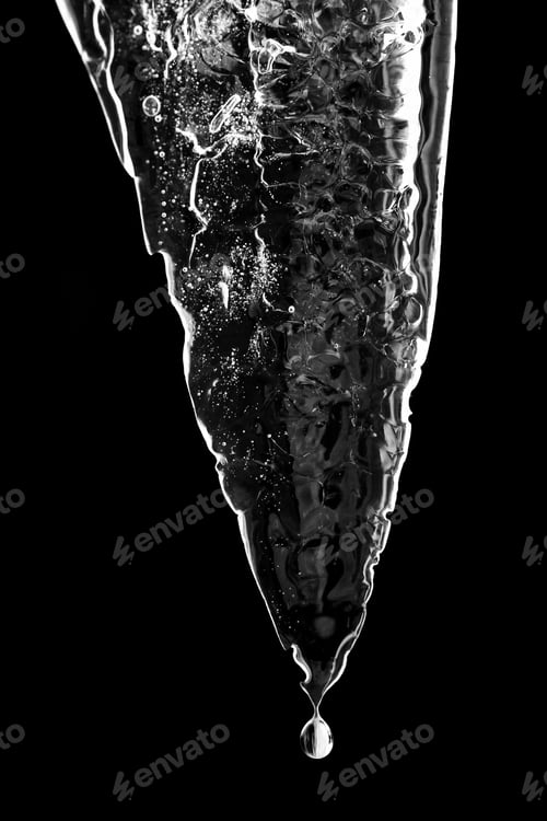 Preview: Grayscale shot of a melting icicle under the lights against a dark background