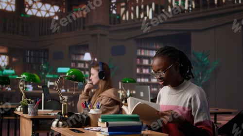 Preview: African american girl does bachelor paper research for citations and information