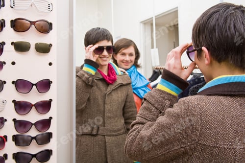 Preview: A woman trying on sunglasses