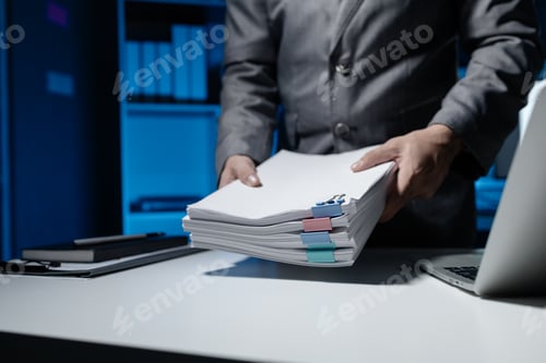 Preview: An employee held a large pile of documents in his hand, Large piles of work documents on desks are b