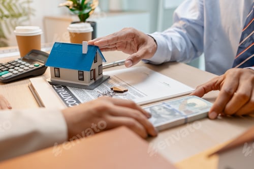 Preview: A real estate agent presents a property sale contract to a client