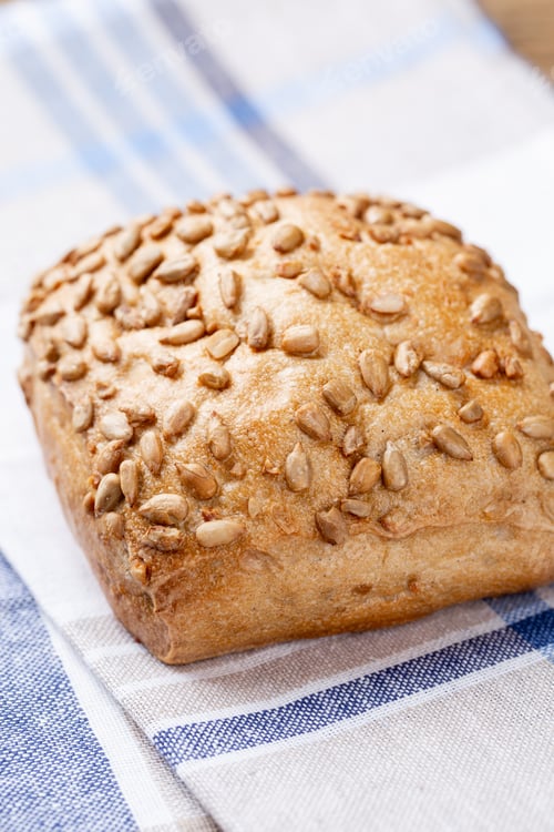 Preview: Freshly baked bread on dark gray kitchen table, top view.