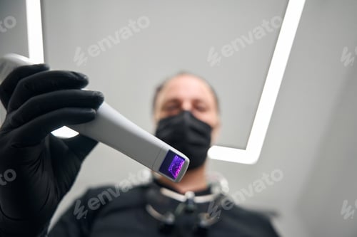 Preview: Doctor holds a special dental device in his hands