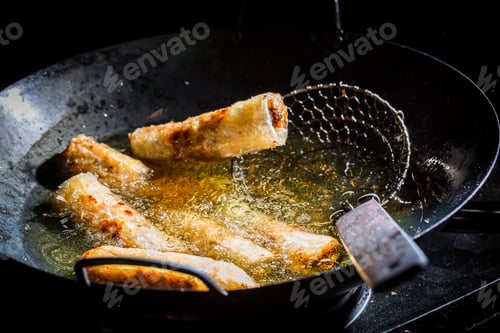 Preview: Homemade spring rolls frying on the pan