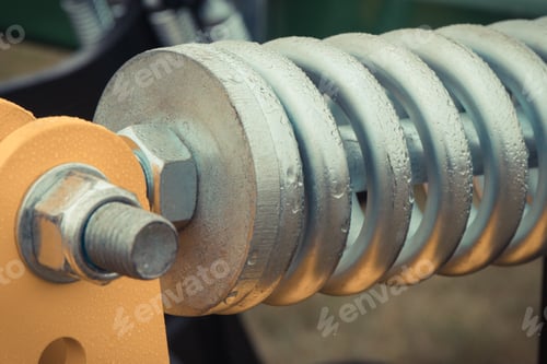 Preview: Silver hard spring made of steel. Part of big industrial or agricultural machine