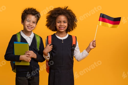 Preview: Two School Children Smiling With German Flag and Books