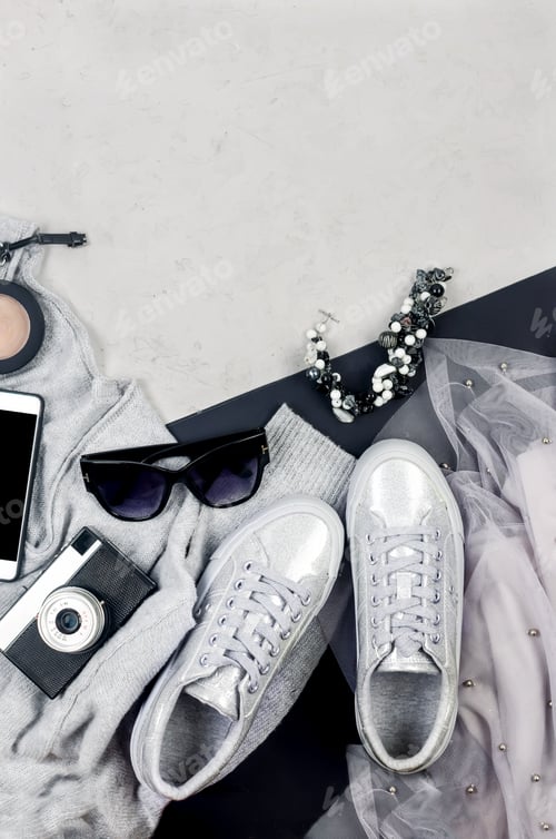 Preview: Silver Sneakers and Accessories on Grey Backdrop