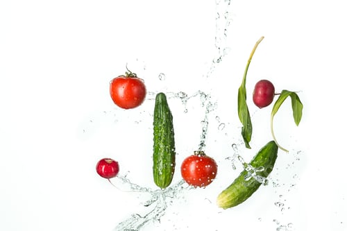 Preview: The fresh tomatos, cucumbers, radish in spray of water.