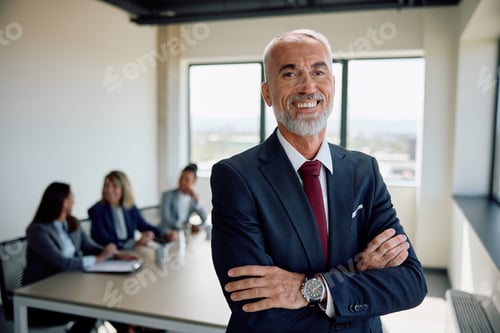 Preview: Portrait of happy mature businessman with arms crossed in meeting room looking at camera.