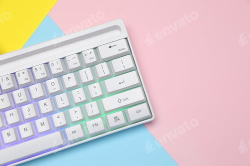 Preview: Modern white keyboard with RGB lighting on color background, top view. Space for text