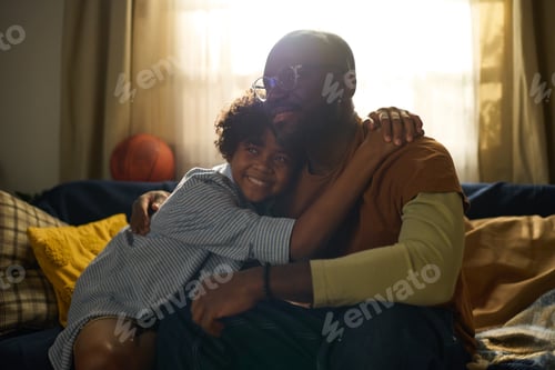 Preview: Father and Child Embracing on a Cozy Couch