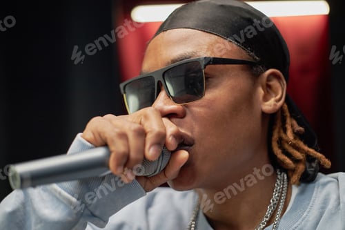 Preview: Young Black Man Performing Rap Song on Stage during Talent Competition