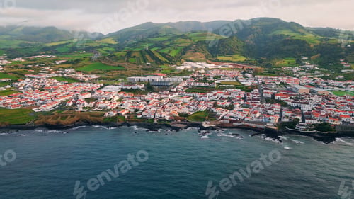 Preview: Aerial serene village coast at green mountains view. Beautiful seaside landscape