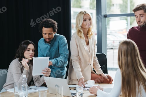 Preview: young multicultural businesspeople discussing business ideas during meeting in office