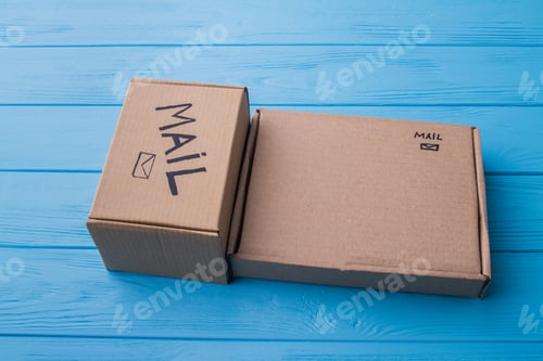 Preview: Two different cardboard boxes on blue wood.
