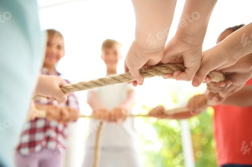 Preview: Little children holding rope on light background, focus on hands. Unity concept