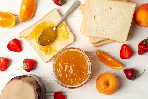 Preview: Composition with apricot jam on white wooden background. Sweet breakfast