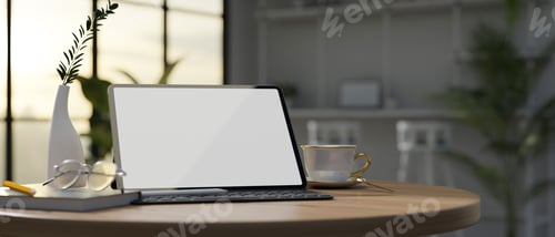 Preview: Tablet mockup on round table with accessories in modern coffee shop or co-working space.
