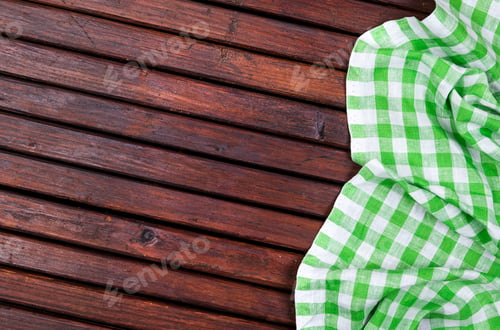 Preview: Green checkered tablecloth on dark wooden table with, top view with copy space