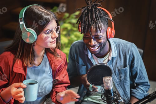 Preview: Multi-ethnic couple wearing headphones talking on the microphone