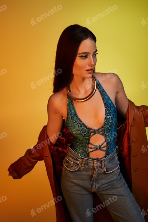 Preview: A beautiful young woman showcases fashionable snake print attire with striking makeup and attire.