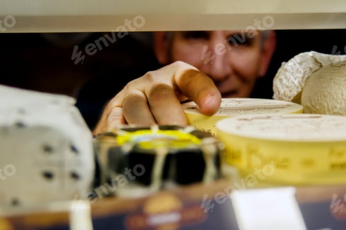 Preview: Cheesemonger arranging cheese in display