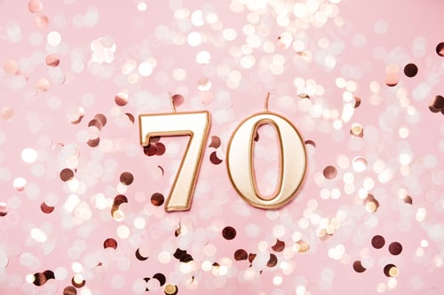Preview: Number 70 seventy golden celebration birthday candle on Festive Background. seventy years birthday.
