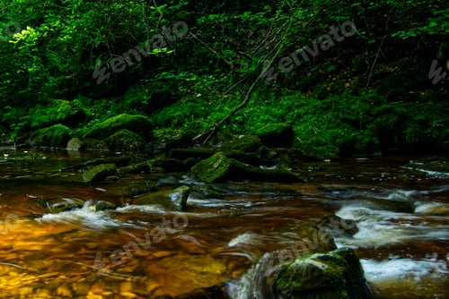 Preview: Flowing river water with mossy rocks on the background